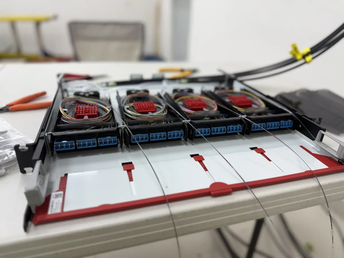 Panel de fibra óptica Siemon durante la instalación, con módulos de empalme y conectores LC